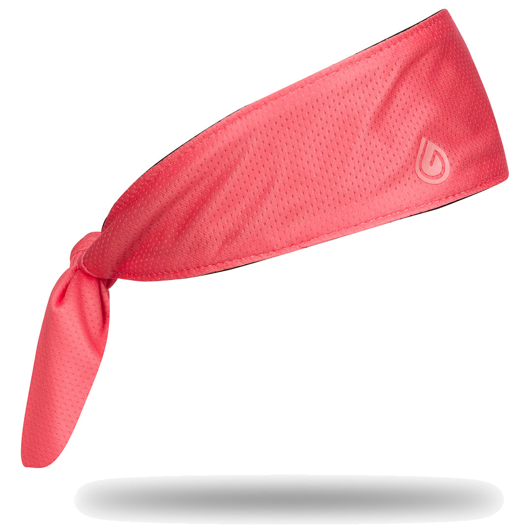 Peach headband with a brand logo on a white background